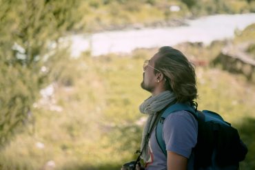 A person hiking in the lush greenery of Nepal, capturing the essence of adventure and natural beauty.